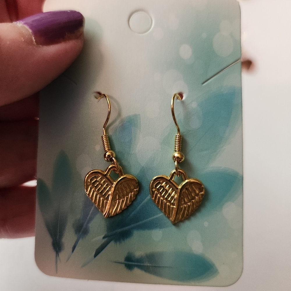 Gold tone heart wing earrings